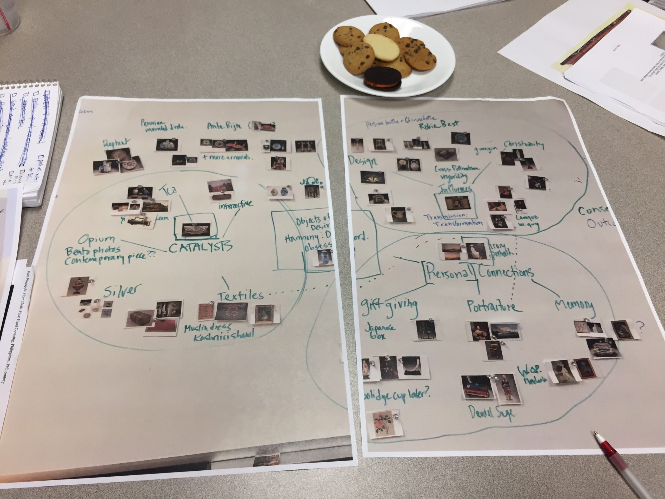 1 conference table with cookies Hand written storyboard with cut out images on a conference room table with a plate of cookies