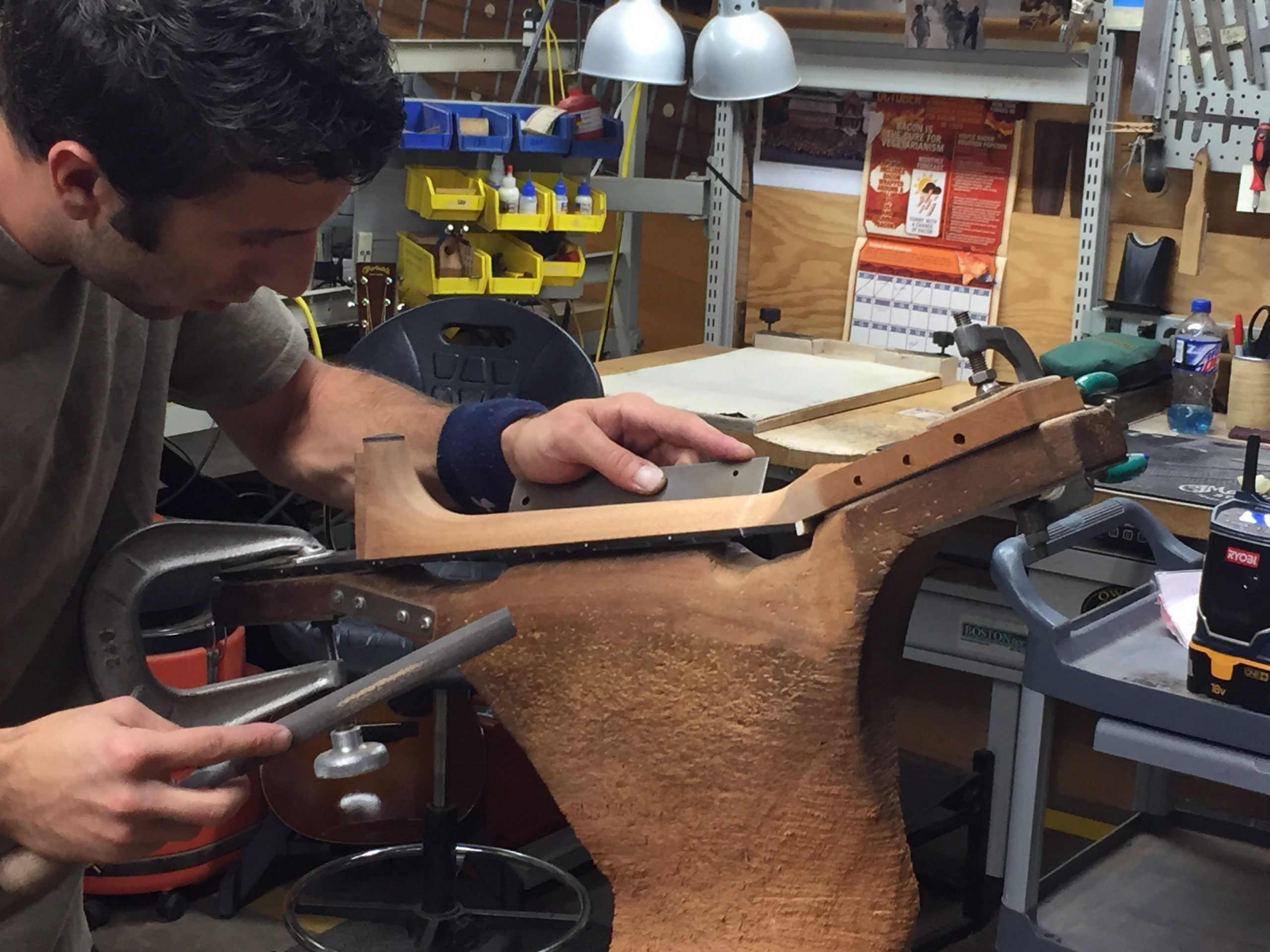 11. martin shaving neck Luthier carving a guitar neck.