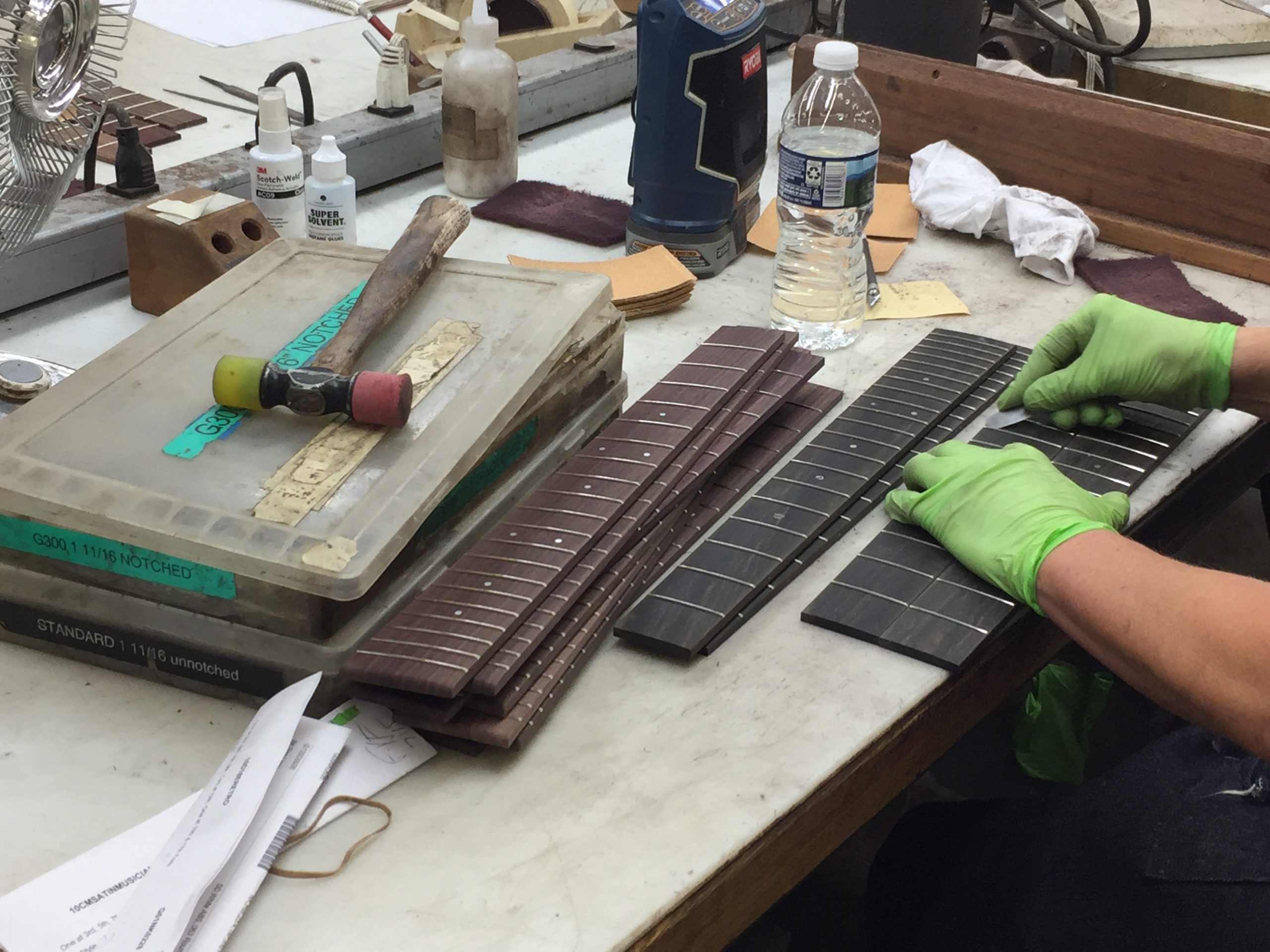 13 martin fret setting A luthier hand setting frets in a guitar.