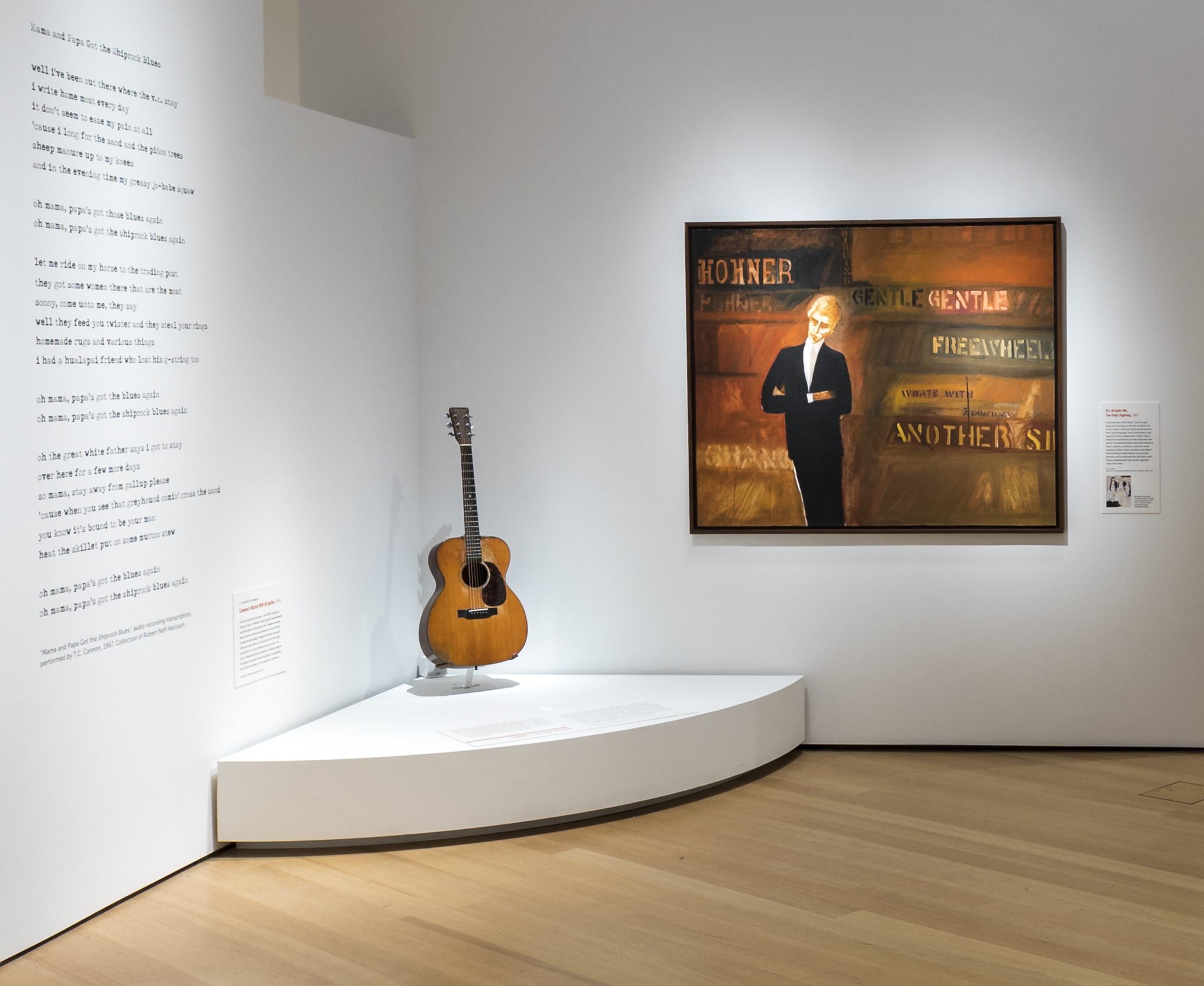 2. TC Cannon 1939 000-18 Martin T.C. Cannon's 1939 000-18 Martin guitar in an art gallery next to a painting