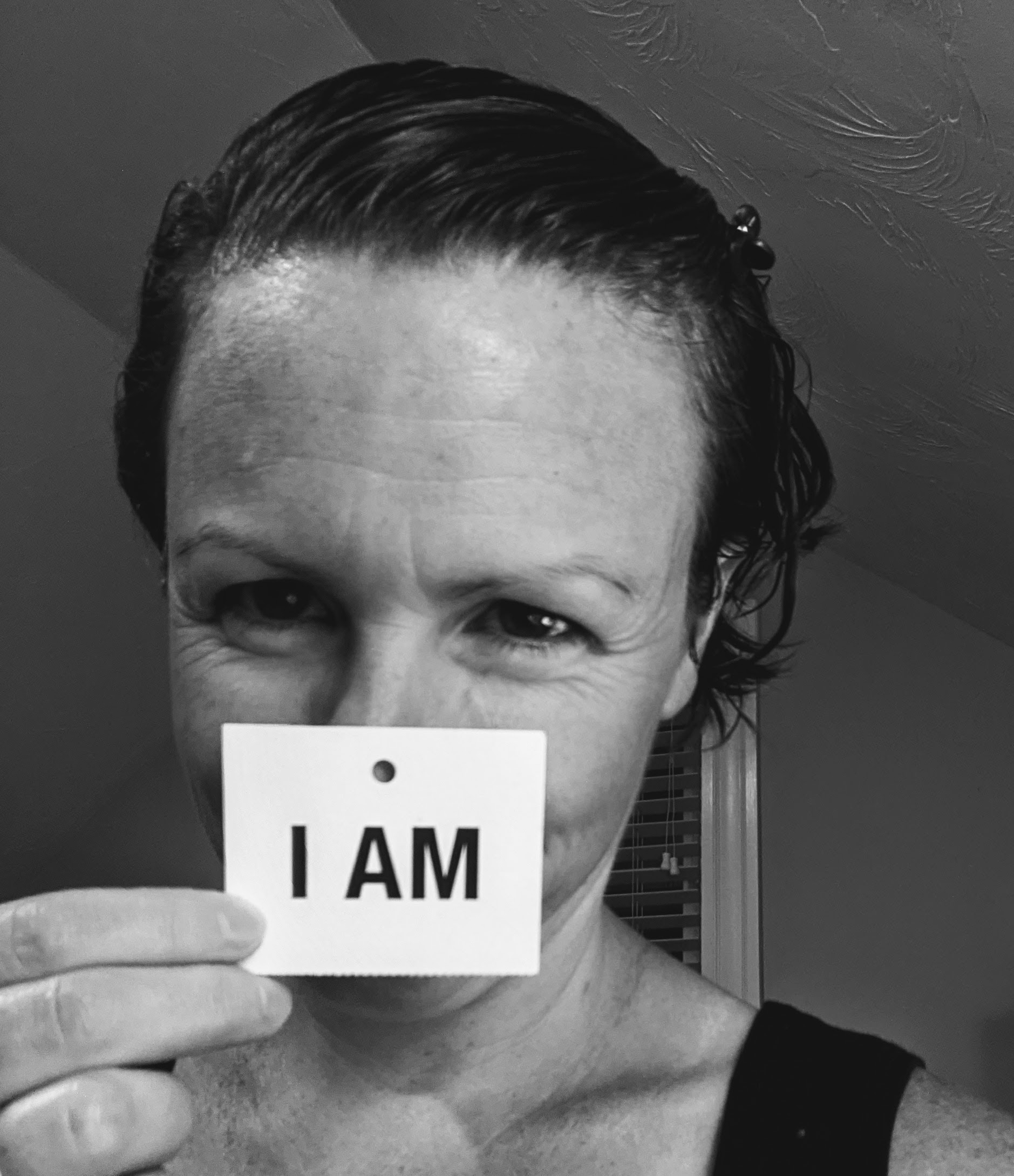annie I am Annie Lundsten holding her I am card.