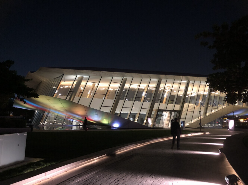 Etihad Museum Etihad Museum at night with lights, dark background, lots of angles, and prism reflection