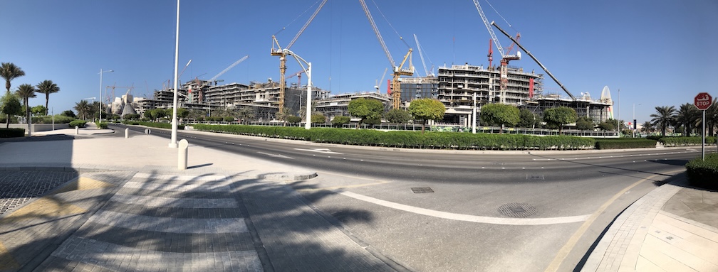 2024-11-15 14.30.01 Buildings, construction and cranes with road in the foreground