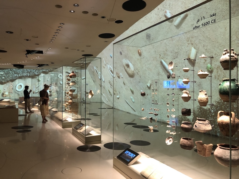 archaeologic display Interior image of gallery with objects in large glass cases on the walls.