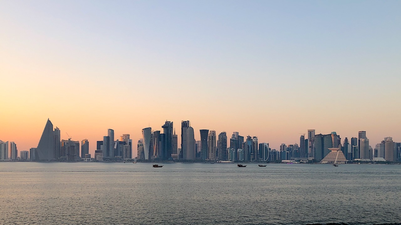 doha skyline Part of Doha skyline at dusk. With blue and orange sky, buildings, and water in the foreground